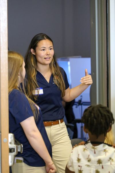 two members of the ninety-nines speaking to a group of kids