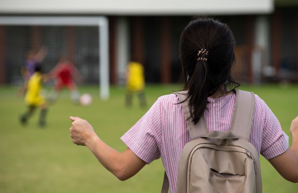 Frustrated mother watching a youth soccer game