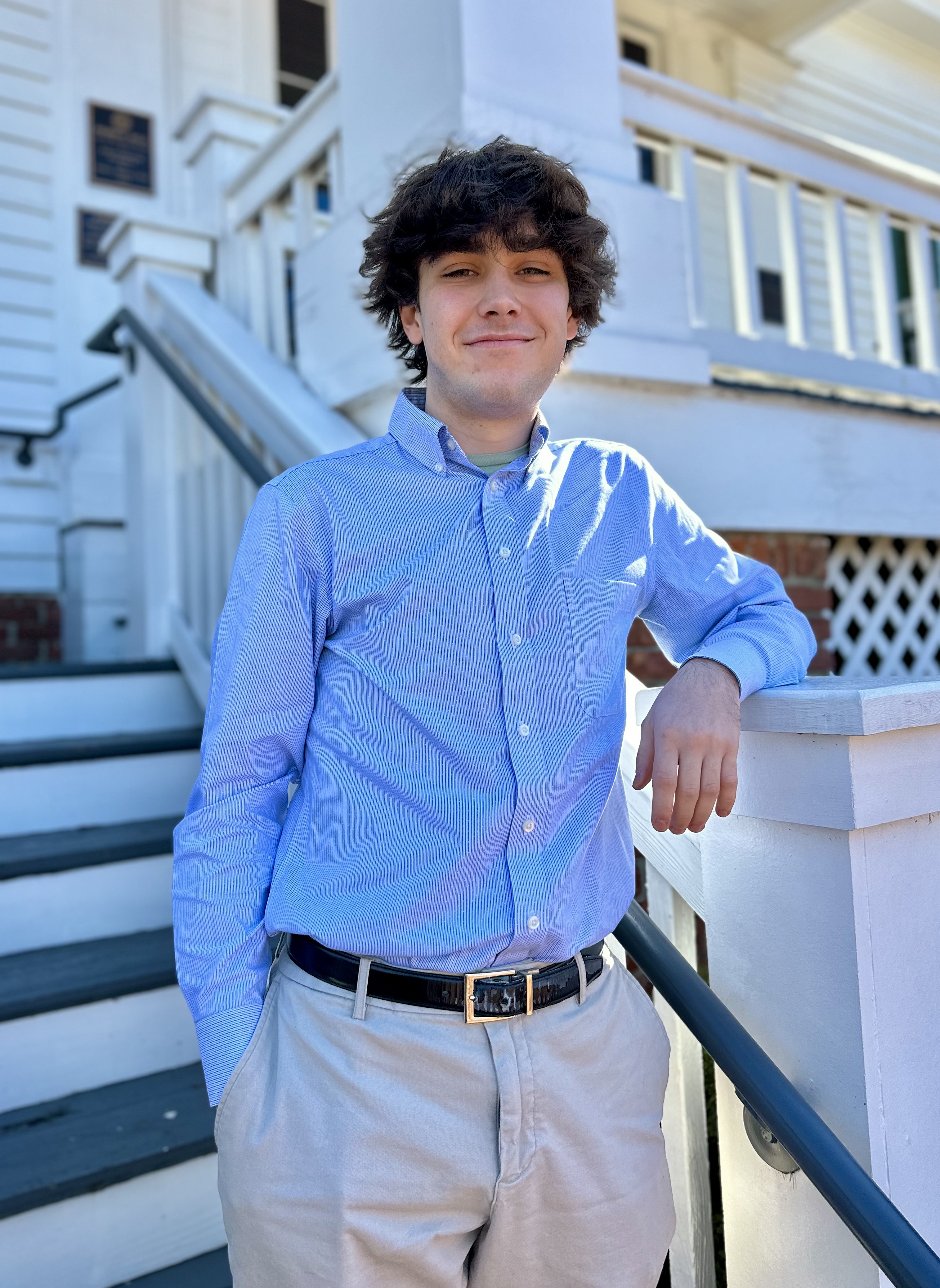 Elisha Oyola stands in front of the steps at Pebble Hill