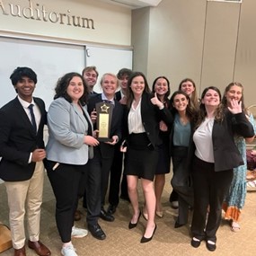 Group of students holding trophy