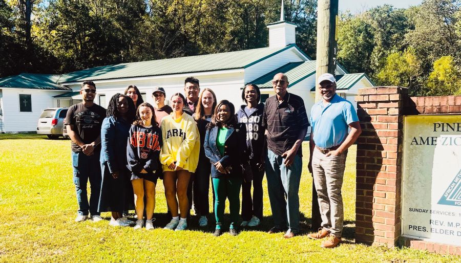 Group of students standing with Catherine Coleman Flowers 