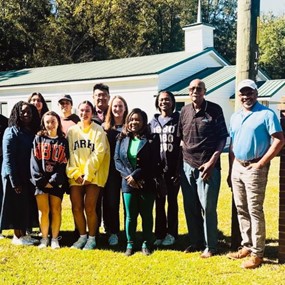 Group of students standing with Catherine Coleman Flowers 