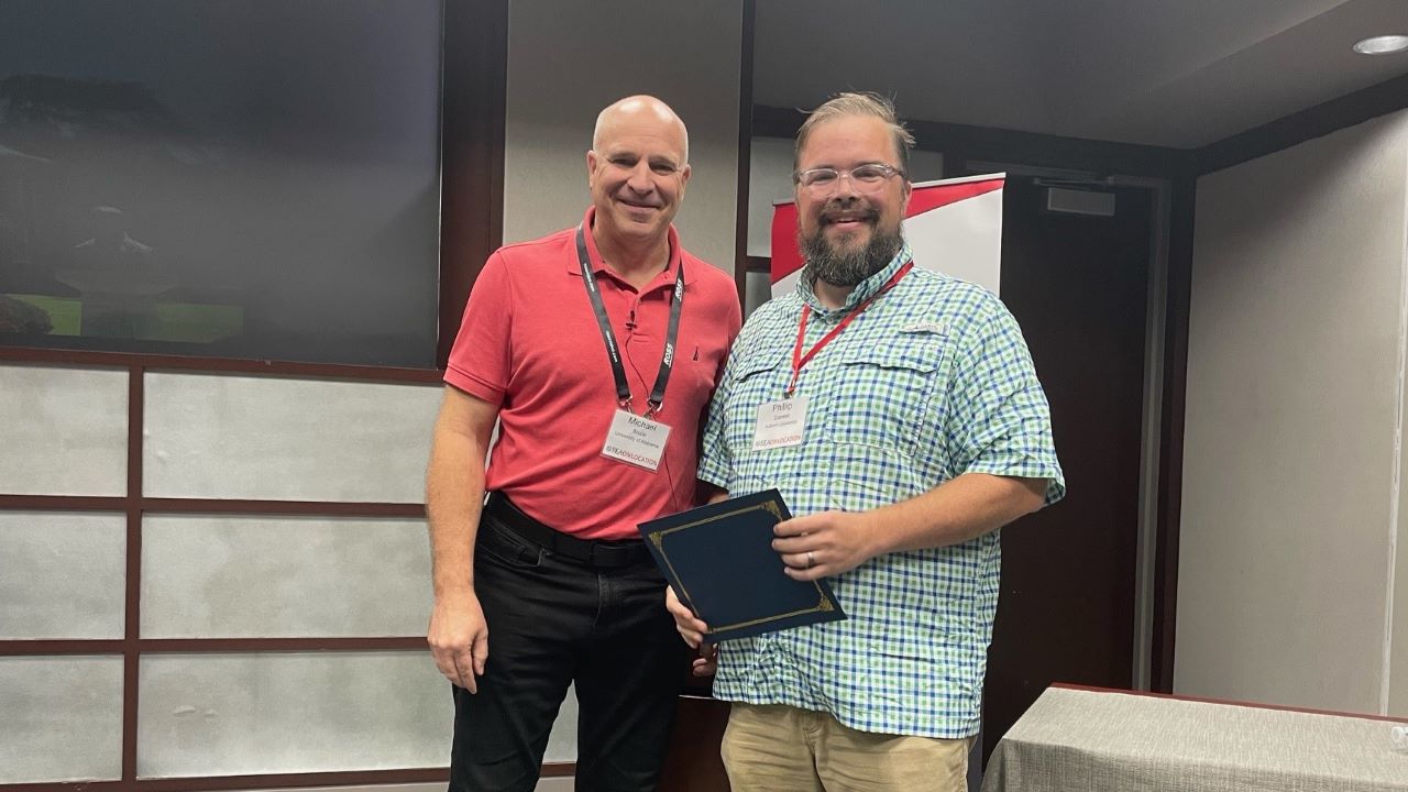 Phillip Coxwell receiving top research in progress award