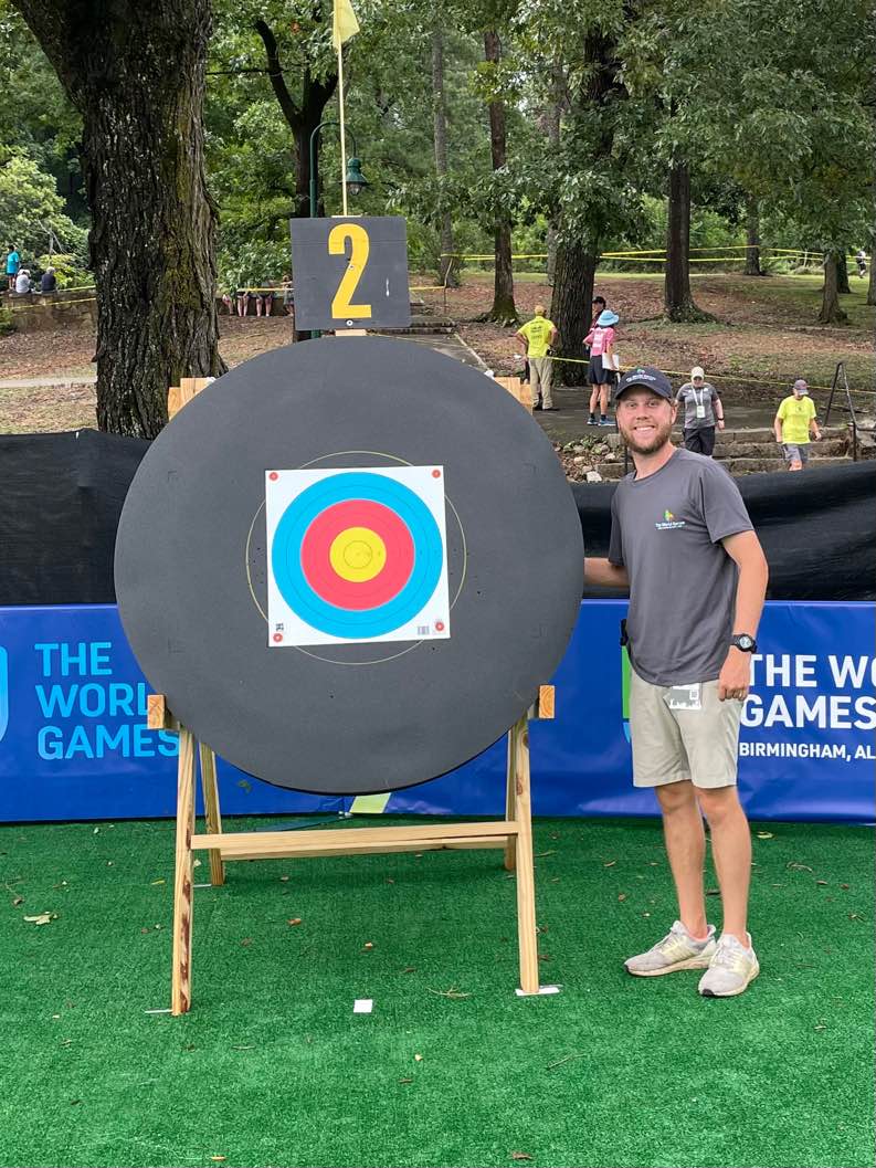 Ben Rushton stands next to target at the World Games in Birmingham