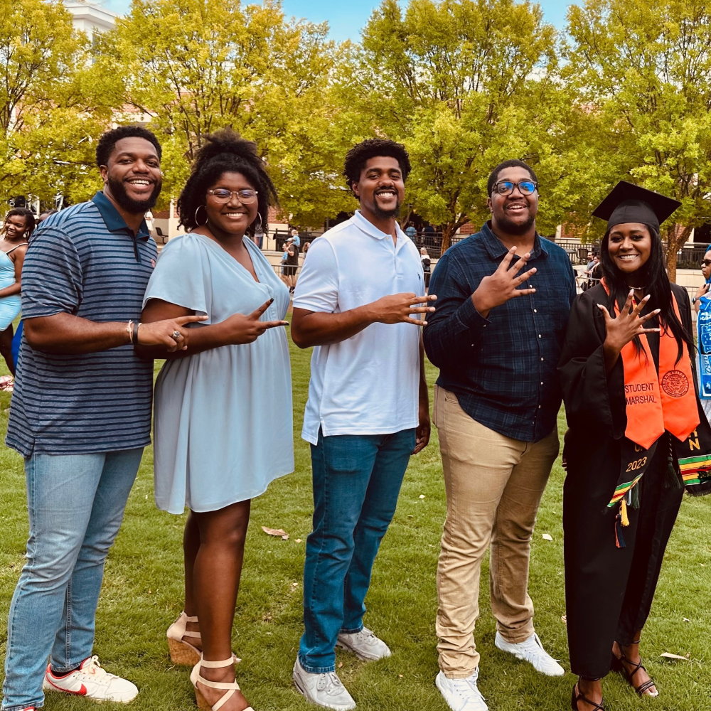 The Bailey siblings pose at Diani's graduation, each holding up the number in order they graduated