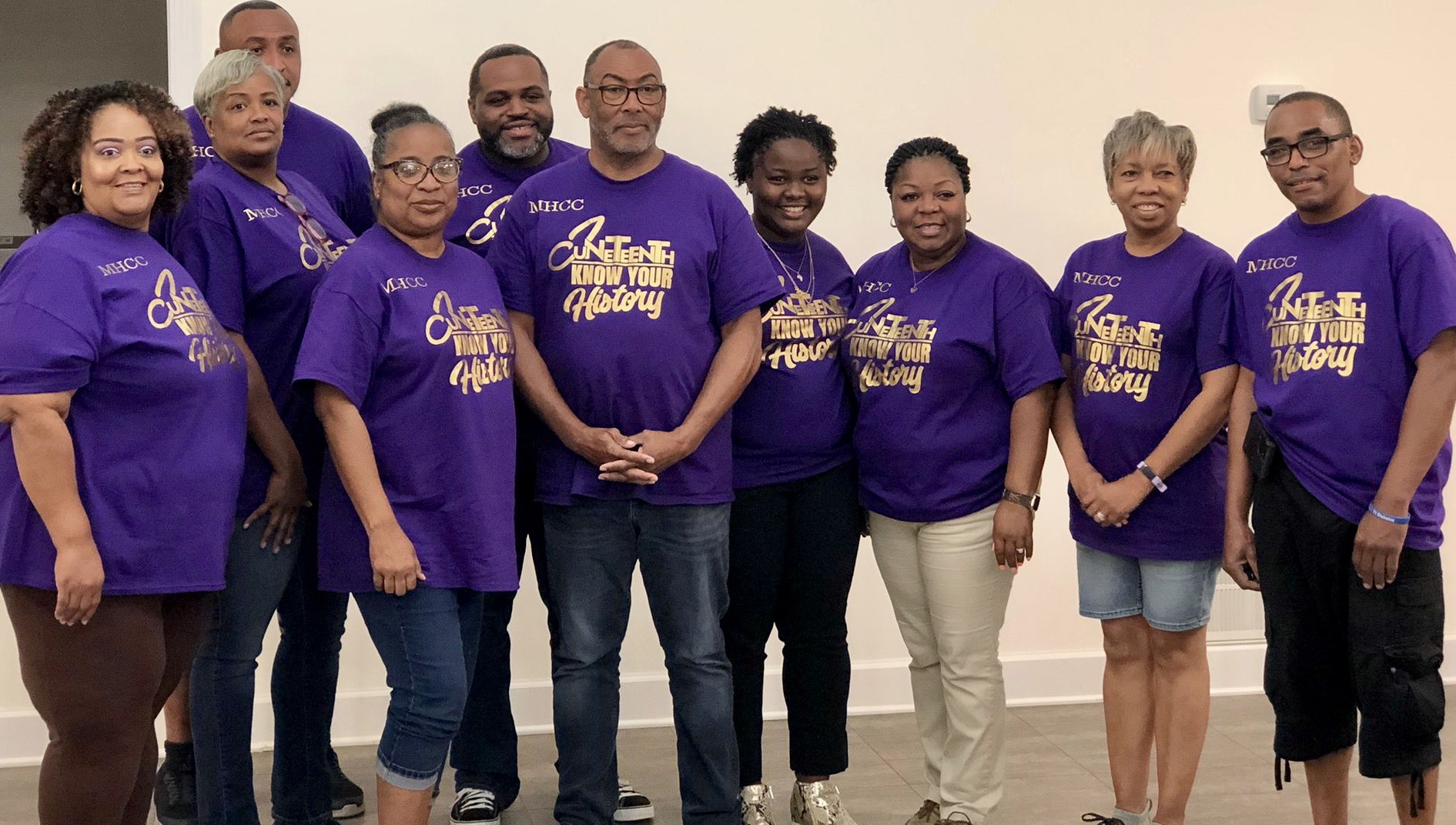 Group of people wearing purple t-shirts