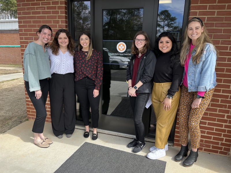 Students standing in front of a glass door