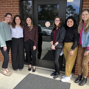 Students standing in front of a glass door