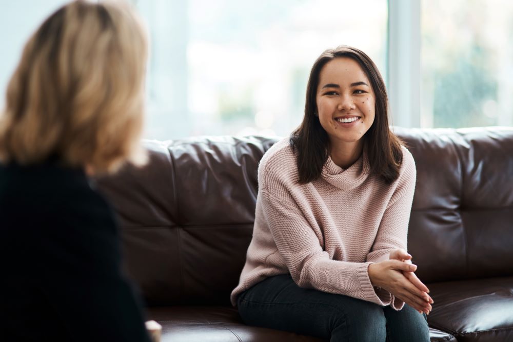A woman smiling during a therapy session