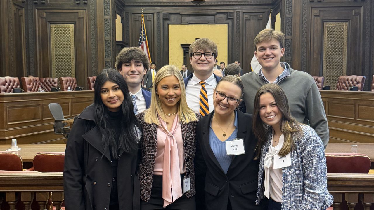 Auburn students posing for a photo inside the US Court of Appeals courtroom