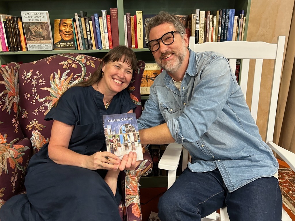 Tina Mozelle Braziel and Jim Braziel holding a copy of their book Glass Cabin