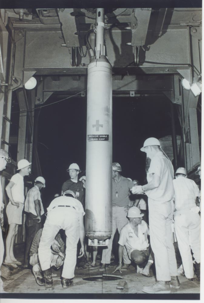 Department of Defense staff lowering nuclear device underground