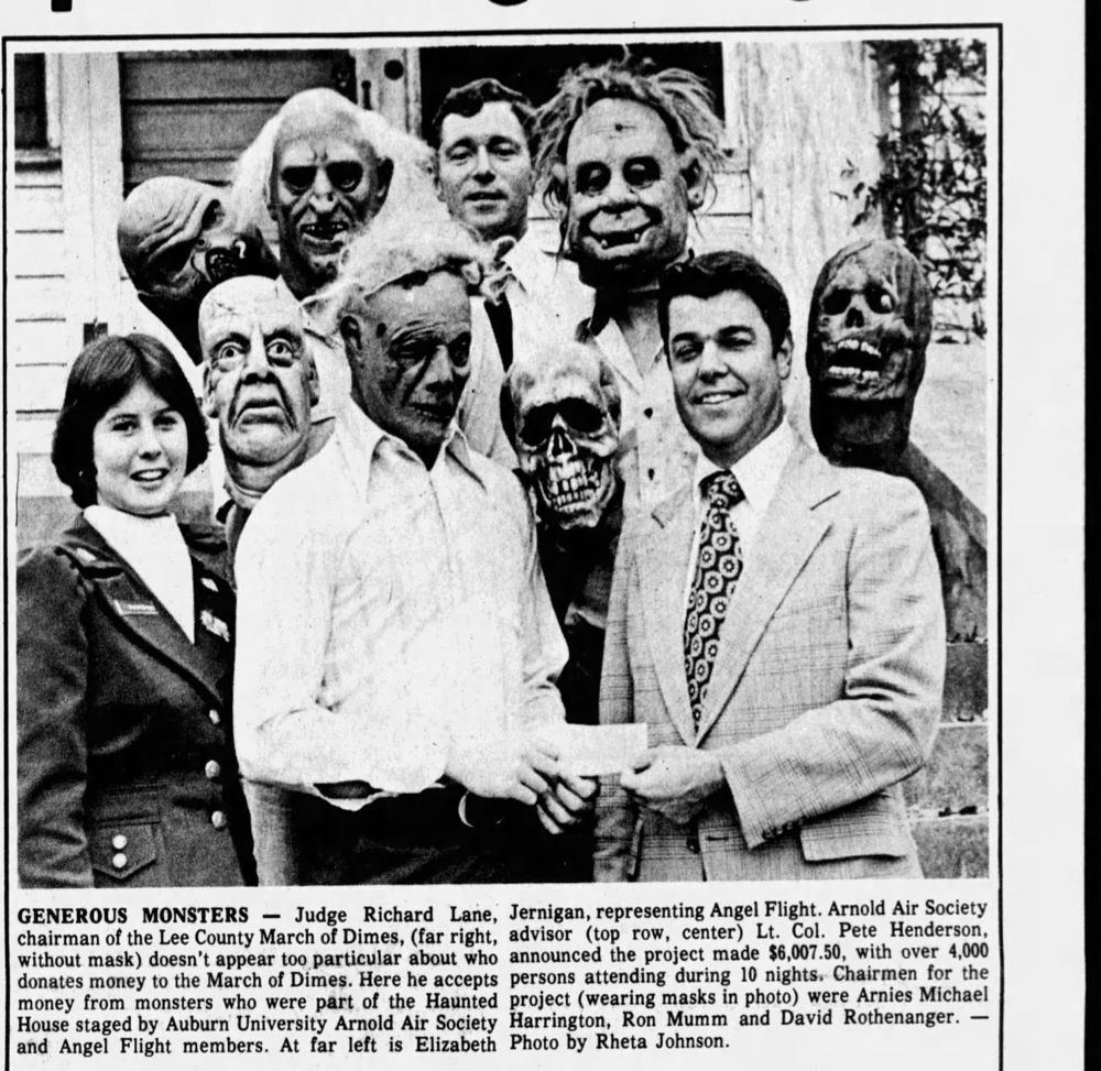 Auburn students in Halloween masks presenting the March of Dimes with a check