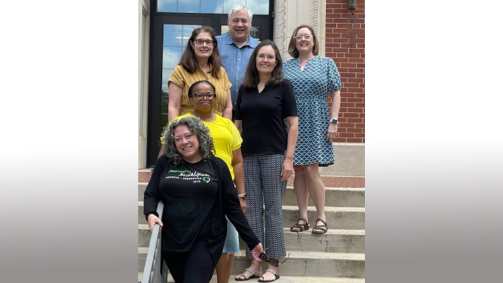 Writing retreat participants pose for a photo on the Tichenor Hall steps