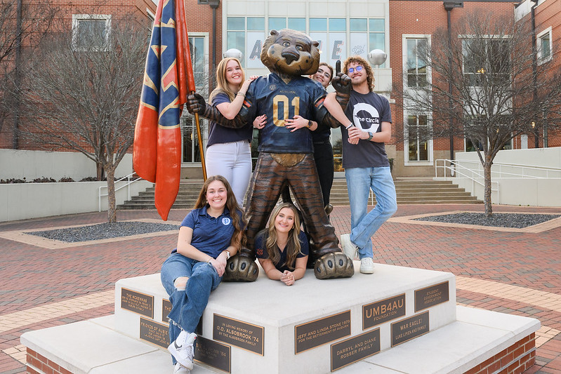 The Fab Five of Student Media pose for a group photo at the Aubie statue