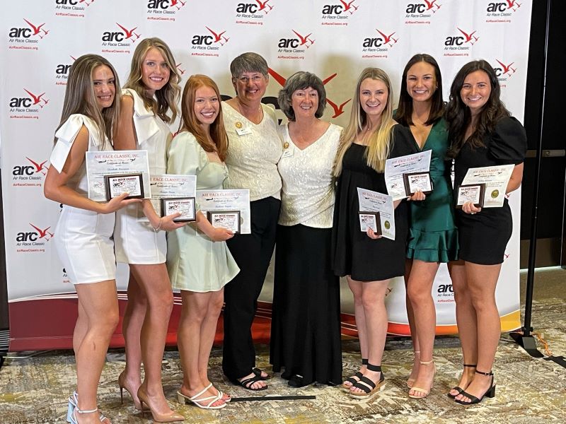 The War Eagle Women stand with awards at the Air Race Classic banquet