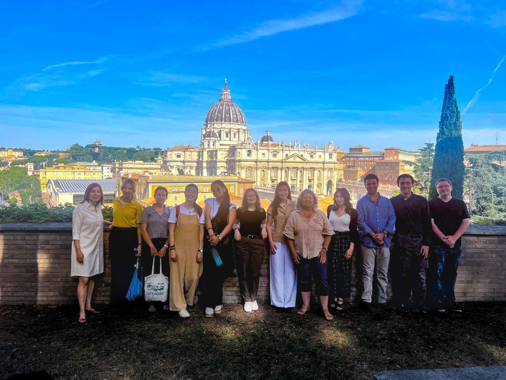 The Rome Summer Archival Seminar group posing for a photo in front of the Vatican