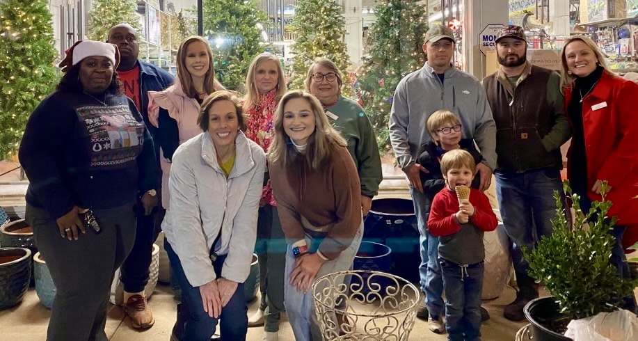 Kawanna Pledger, front left, celebrates with her WoodmenLife group at the 2023 Christmas in Camden event.